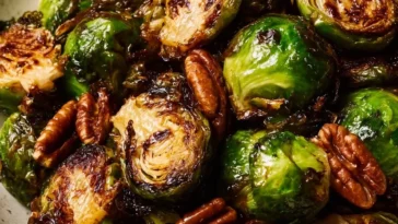 Air Fryer Brussels Sprouts with balsamic glaze and pecans on a plate