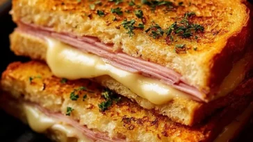 Delicious grilled ham and cheese sandwich made in an air fryer, golden and crispy.