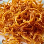 Crispy fried onions made in an Instant Air Fryer, golden and crunchy.