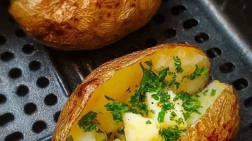 Crispy air fryer baked potatoes served with toppings on a plate