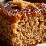 12-slice oatmeal ginger cake with ginger frosting on a wooden table