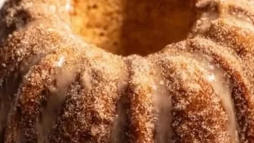 Delicious Apple Cider Bundt Cake displayed on a rustic wooden table.