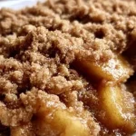 Delicious homemade apple crisp served in a bowl with a scoop of vanilla ice cream