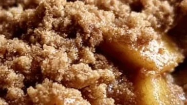 Delicious homemade apple crisp served in a bowl with a scoop of vanilla ice cream