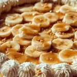 Slice of banana pudding cheesecake with a graham cracker crust and banana slices