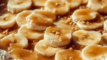 Slice of banana pudding cheesecake with a graham cracker crust and banana slices