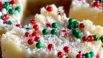 No-bake Christmas sugar cookie cheesecake bars on a holiday plate.