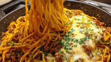 Creamy Cajun Beef Spaghetti topped with triple cheese Parmesan sauce