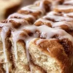 Delicious Dollywood cinnamon bread topped with creamy icing ready to be enjoyed.