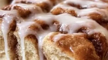 Delicious Dollywood cinnamon bread topped with creamy icing ready to be enjoyed.