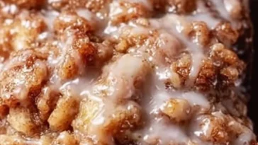 Slice of Amish apple fritter bread with apples and cinnamon glaze