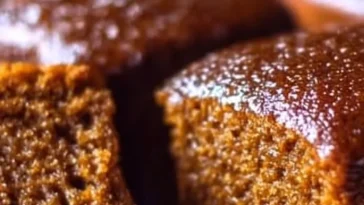 Delicious gingerbread cake topped with frosting and holiday decorations