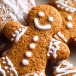 Baked soft gingerbread cookies decorated with icing on a wooden table