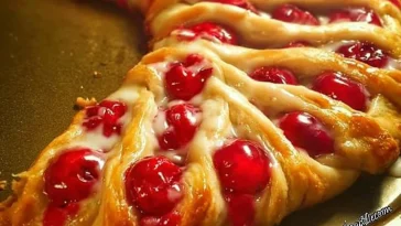 Festive Candy Cane Cheese Danish topped with peppermint and cream cheese filling