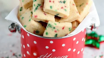 Festive Christmas shortbread cookie bites on a decorative plate