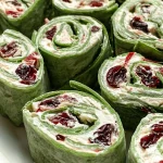 Cranberry Jalapeño Pinwheels on a platter, showcasing vibrant colors and textures.