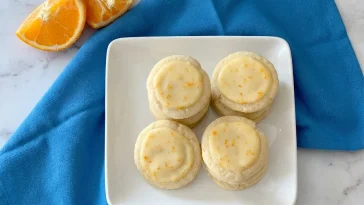 Freshly baked Orange Meltaway Cookies on a cooling rack