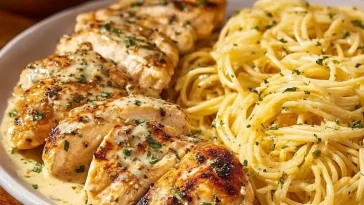 A bowl of Garlic Parmesan Cheddar Chicken Linguine with rich, cheesy flavor.